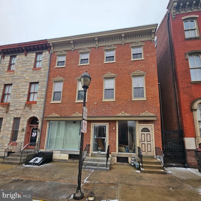 multi unit property featuring entry steps and brick siding