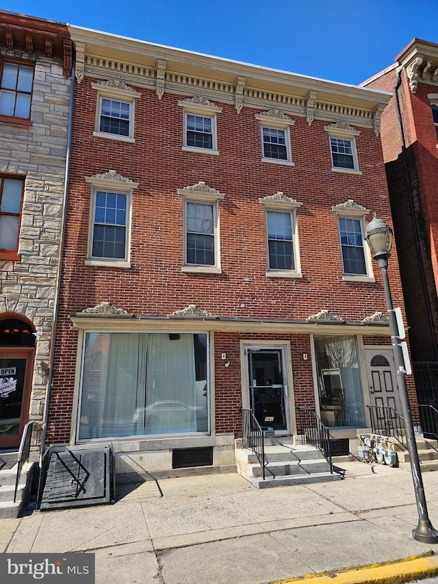 view of front of home featuring entry steps and brick siding