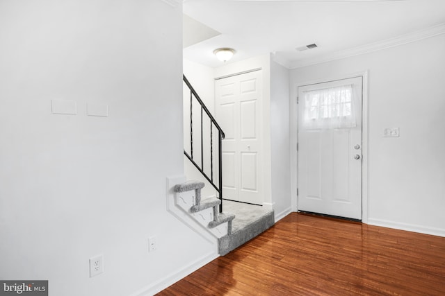 entryway featuring ornamental molding and wood-type flooring