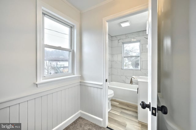 full bathroom featuring vanity, toilet, tiled shower / bath combo, and hardwood / wood-style floors