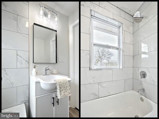 bathroom featuring vanity and tiled shower / bath