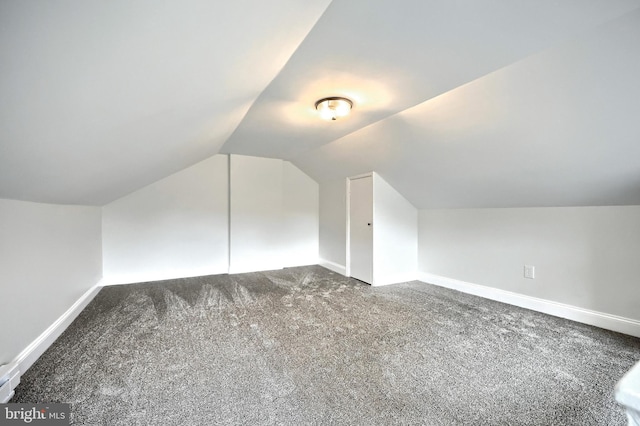 additional living space with carpet floors and vaulted ceiling