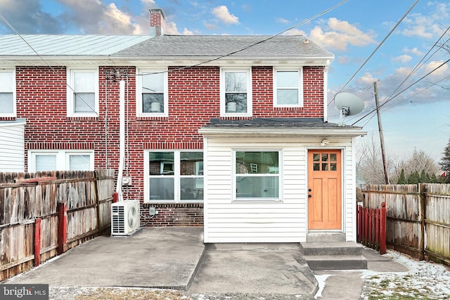 rear view of property with a patio and ac unit