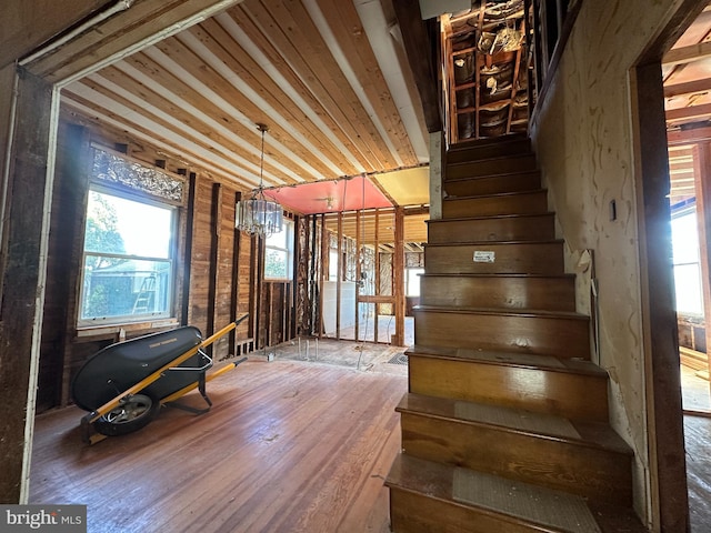 6308 Beechwood, Idlewylde, MD 21239 - stairway with hardwood / wood-style floors and a notable chandelier