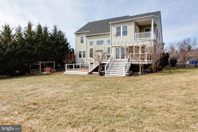 back of property with a yard, a deck, and a pergola