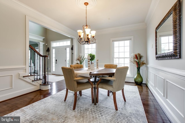 dining room featuring ornamental molding, a chandelier, and dark hardwood / wood-style flooring