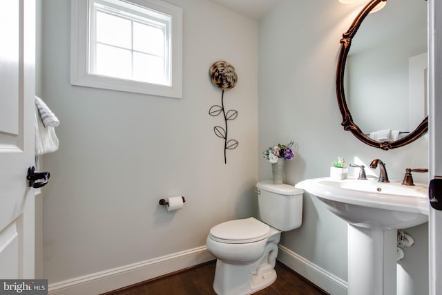 bathroom with sink, toilet, and hardwood / wood-style floors