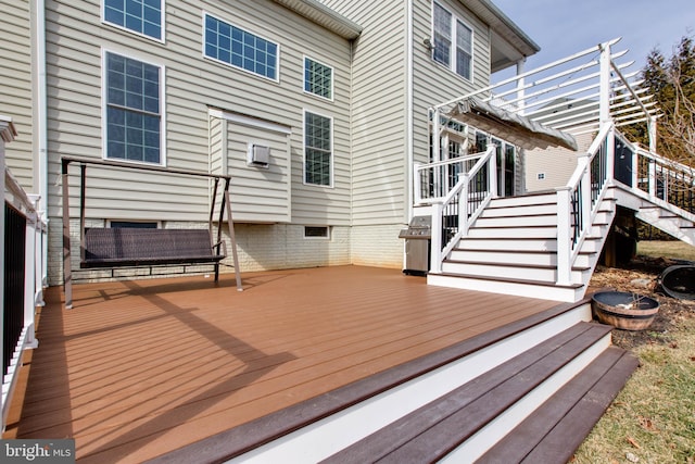 deck featuring a fire pit and a pergola