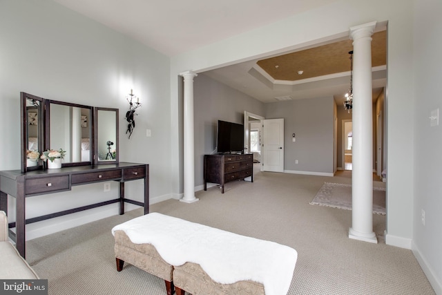 living area featuring light carpet, decorative columns, and a raised ceiling