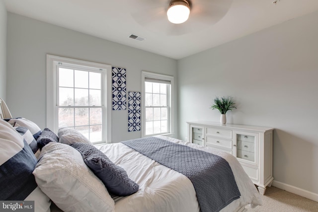 bedroom with ceiling fan and light colored carpet