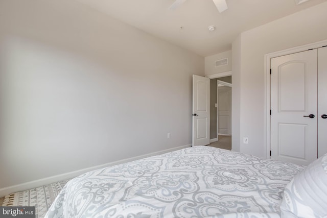 bedroom featuring a closet, light colored carpet, and ceiling fan