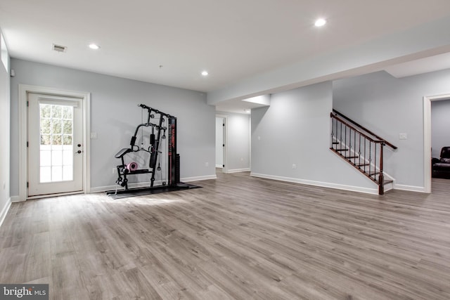 exercise room featuring light wood-type flooring