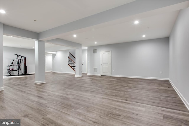 basement with light hardwood / wood-style flooring