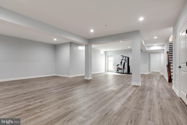 basement with light hardwood / wood-style flooring