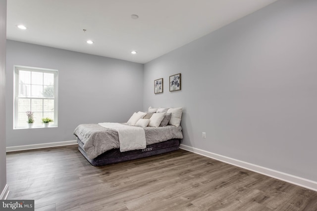 bedroom with hardwood / wood-style floors