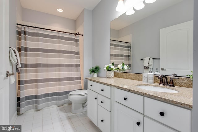 bathroom featuring tile patterned floors, toilet, and vanity