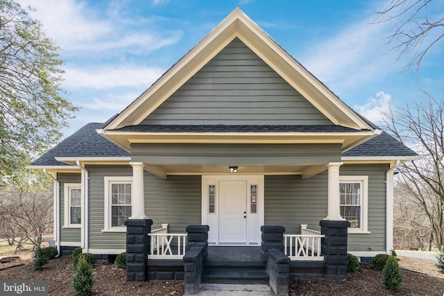 view of front of home with covered porch and a shingled roof