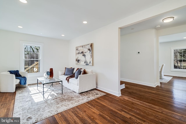 living area with recessed lighting, a healthy amount of sunlight, and wood finished floors