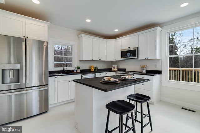 kitchen featuring a sink, visible vents, appliances with stainless steel finishes, and white cabinets