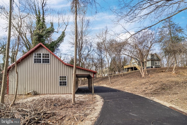 view of home's exterior with an attached carport and board and batten siding