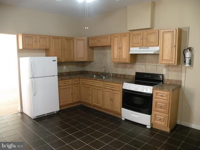 kitchen with sink, backsplash, white fridge, range with electric cooktop, and light brown cabinets