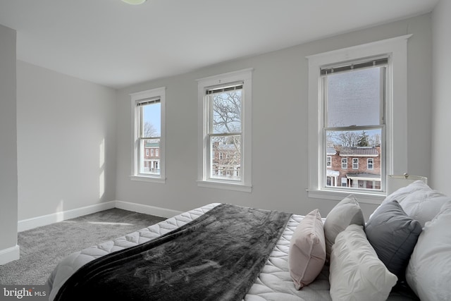 bedroom featuring carpet flooring and baseboards