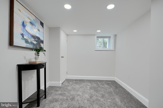 basement featuring baseboards, recessed lighting, and light colored carpet