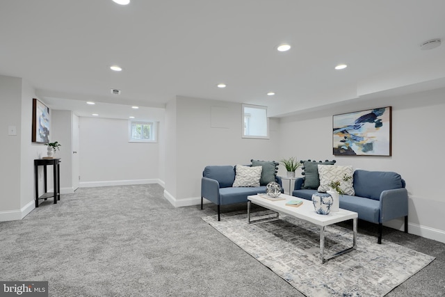 carpeted living room with visible vents, baseboards, and recessed lighting