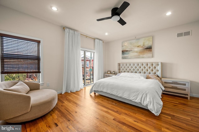 bedroom with hardwood / wood-style flooring, access to exterior, and ceiling fan