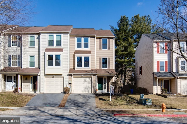 multi unit property with driveway and an attached garage