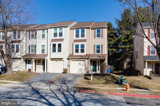 townhome / multi-family property featuring driveway and an attached garage