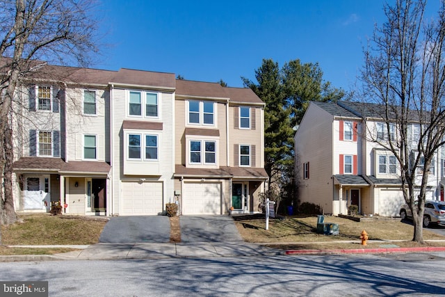 townhome / multi-family property featuring a garage and driveway