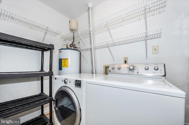 laundry room featuring water heater and separate washer and dryer