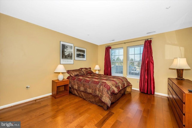 bedroom with hardwood / wood-style flooring