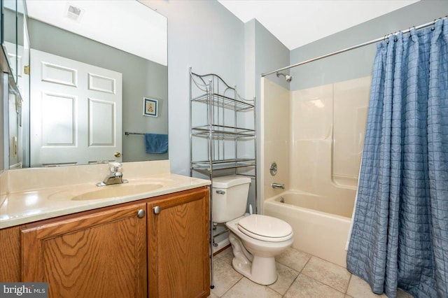 full bathroom featuring tile patterned floors, toilet, shower / bath combo with shower curtain, and vanity