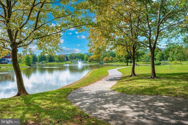 view of property's community featuring a yard and a water view