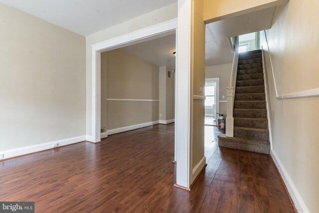 stairway featuring baseboards and wood finished floors