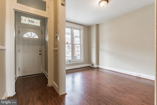 entryway with dark wood-style flooring, visible vents, and baseboards