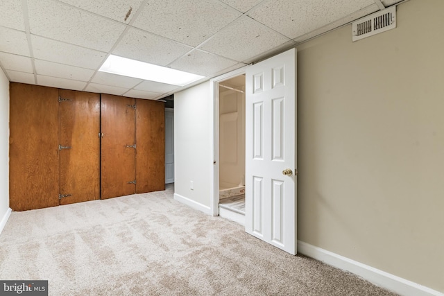 unfurnished bedroom featuring a closet, visible vents, light carpet, and baseboards