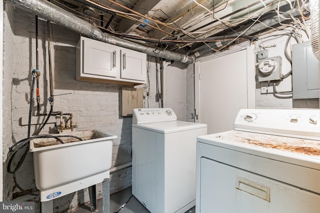 laundry area with a sink, cabinet space, washing machine and clothes dryer, and electric panel