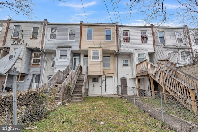 view of property with stairs and fence