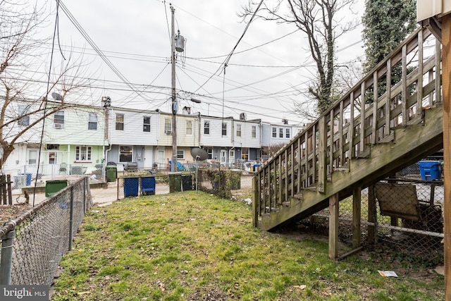 view of yard with stairway and fence