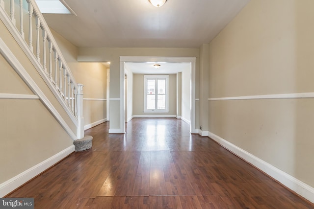 entrance foyer featuring stairs, dark wood finished floors, and baseboards