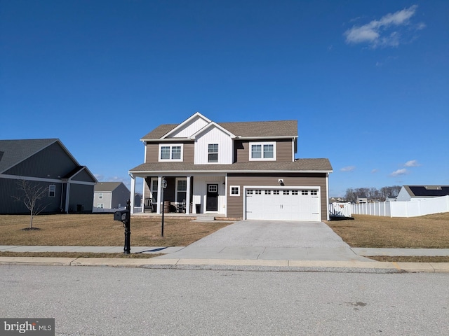 view of front facade featuring a garage, a front lawn, and covered porch