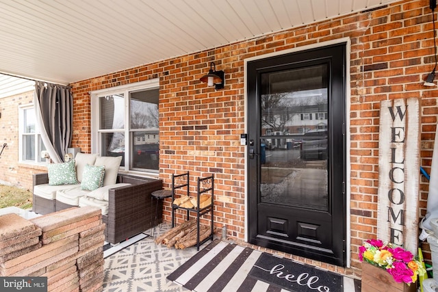 property entrance featuring brick siding