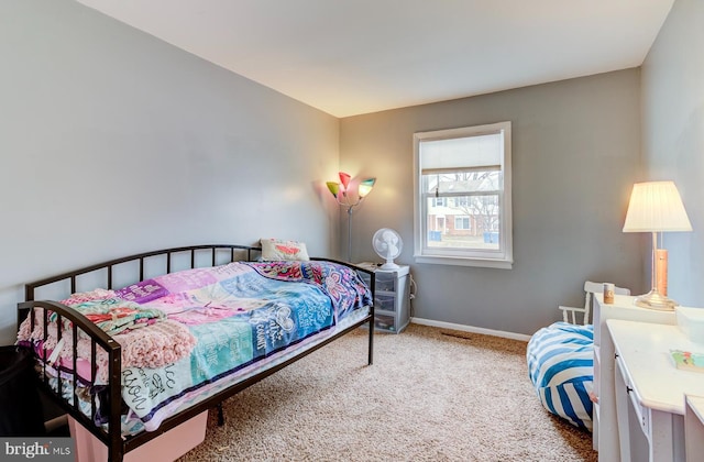 bedroom featuring carpet and baseboards