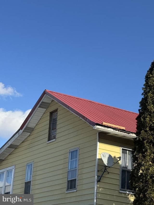 view of side of home featuring metal roof