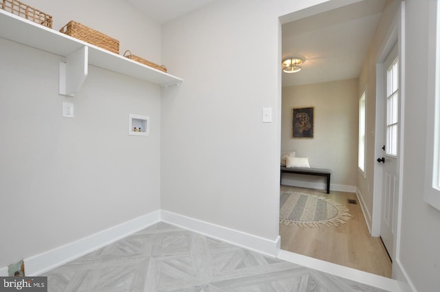 laundry area featuring washer hookup, laundry area, parquet floors, and baseboards