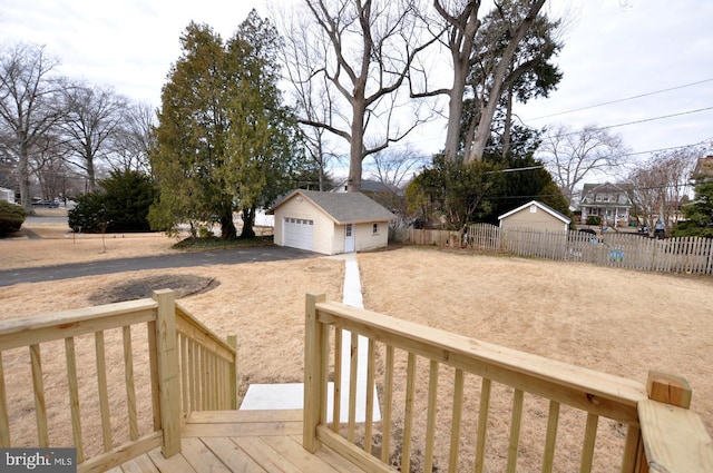 view of yard with a garage, fence, and an outdoor structure