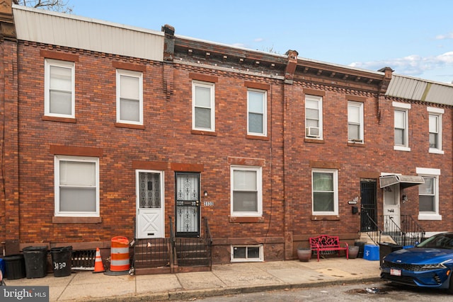 view of front of house featuring entry steps and brick siding